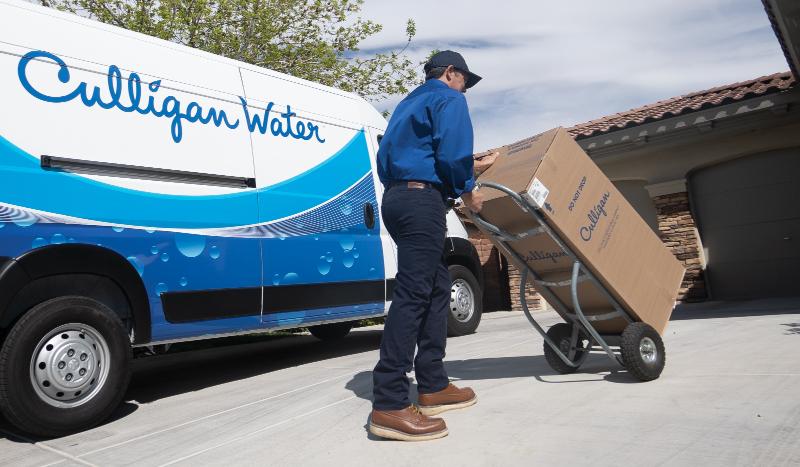 Culligan Employee Transporting Water